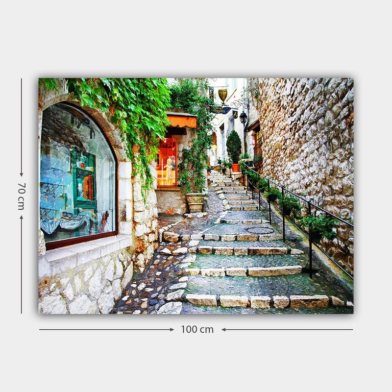 Canvastavla 70x100 cm - Charmig gränd med stenar och grönska som leder uppåt, omgiven av historiska byggnader - Grön / Beige / Orange - Inredning & dekor - Tavlor & konst - Canvastavla