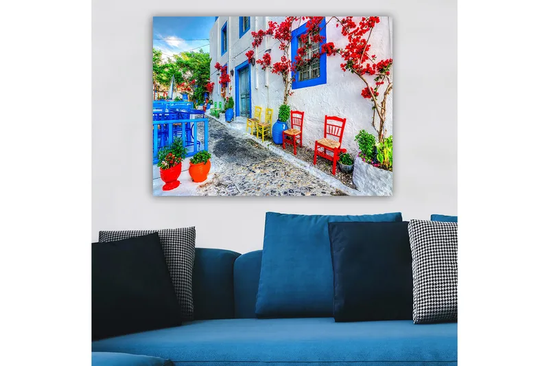 Canvastavla 70x100 cm - Färgglad gata med blommor och stolar i olika färger som skapar en livlig atmosfär - Blå / Röd / Grön - Inredning & dekor - Tavlor & konst - Canvastavla