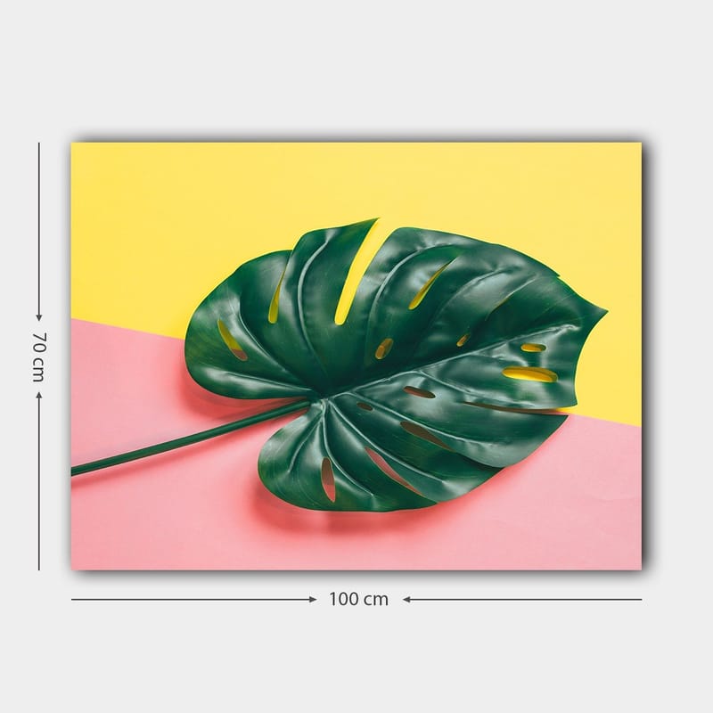 Canvastavla 70x100 cm - Stor, grön monstera-blad mot en färgglad bakgrund av gul och rosa - Grön / Gul / Rosa - Inredning & dekor - Tavlor & konst - Canvastavla