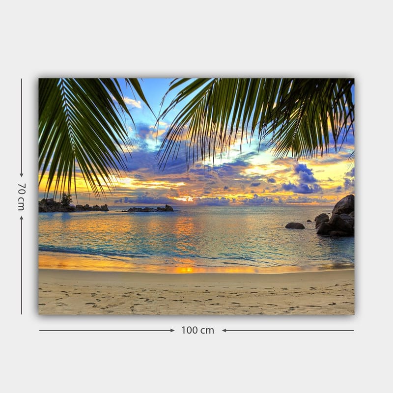 Canvastavla 70x100 cm - Vacker solnedgång över en strand med palmer som ramar in motivet - Blå / Orange / Grön - Inredning & dekor - Tavlor & konst - Canvastavla