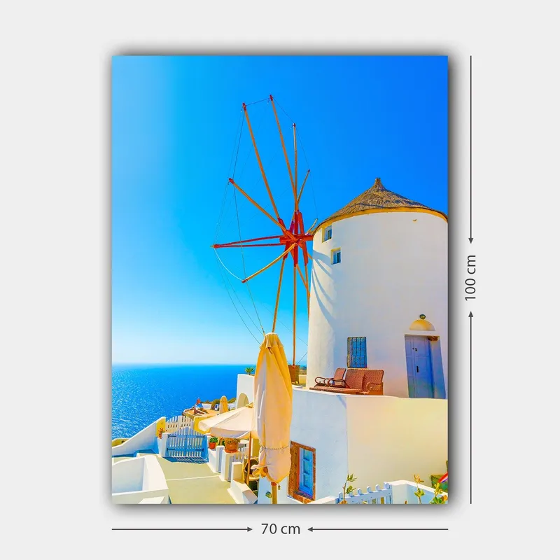 Canvastavla 70x100 cm - Vit vindmölla med röd rotor på en klippa vid havet, omgiven av klarblå himmel och hav - Vit / Röd / Blå - Inredning & dekor - Tavlor & konst - Canvastavla
