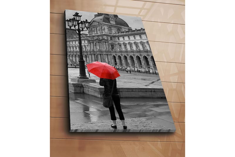 Canvastavla 70x100 cm - Person står med ett rött paraply i en regnig stadsmiljö framför en historisk byggnad - Röd / Svart - Inredning & dekor - Tavlor & konst - Canvastavla